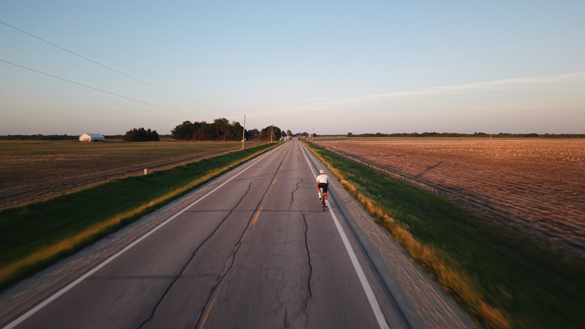 Cyclist on a long country road