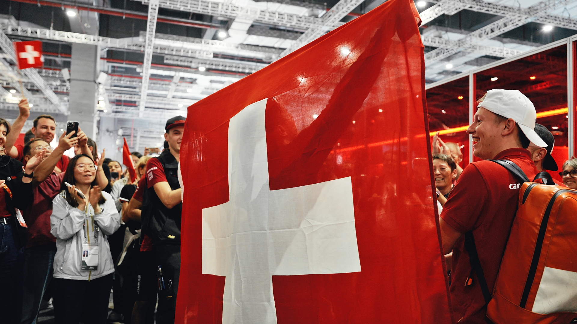 Swiss flag held up in a cheering crowd